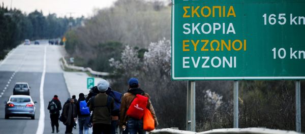 Stranded refugees walk through a national motorway towards the Greek-Macedonian border near the Greek town of Polykastro after ignoring warnings from Greek authorities that the border is shut, as hundreds of migrants set off on the country's main north-south motorway to Idomeni border crossing February 25, 2016. Stranded refugees walk through a national motorway towards the Greek-Macedonian border near the Greek town of Polykastro after ignoring warnings from Greek authorities that the border is shut, as hundreds of migrants set off on the country's main north-south motorway to Idomeni border crossing February 25, 2016. - Sputnik International