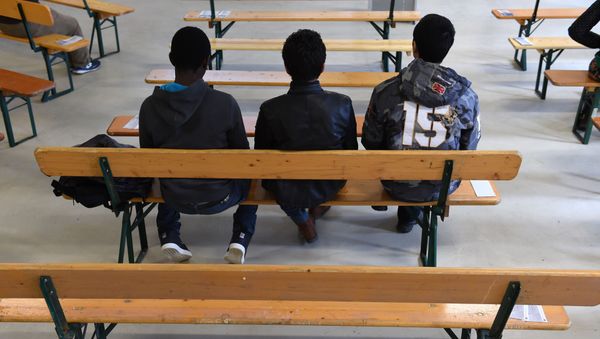 Migrants wait for the start of the rights education lessons for refugees and asylum seekers Migrants wait for the start of the rights education lessons for refugees and asylum seekers - Sputnik International
