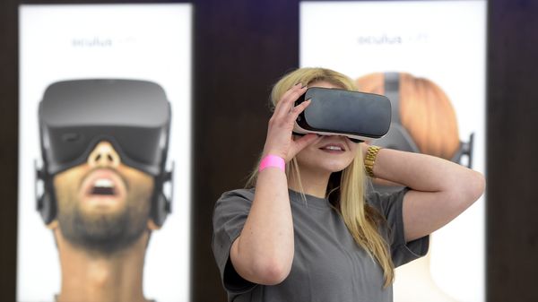 A woman uses a virtual reality device. - Sputnik International