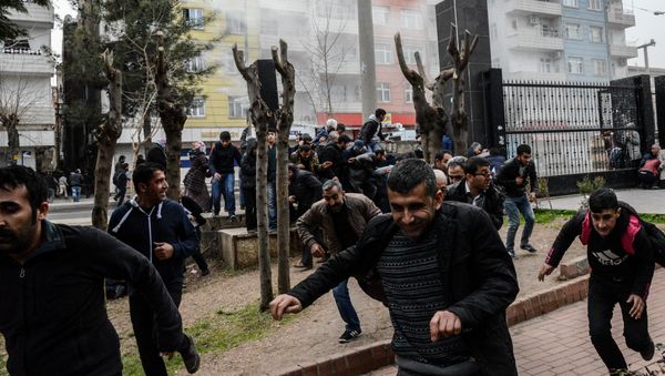 People disperse as Turkish police fire tear gas in Diyarbakir on February 27, 2016 during a demonstration against government-imposed curfews on areas of eastern Turkey People disperse as Turkish police fire tear gas in Diyarbakir on February 27, 2016 during a demonstration against government-imposed curfews on areas of eastern Turkey - Sputnik International