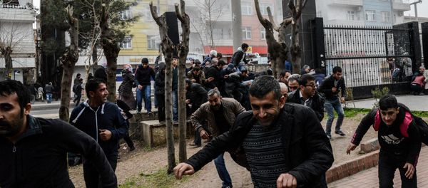 People disperse as Turkish police fire tear gas in Diyarbakir on February 27, 2016 during a demonstration against government-imposed curfews on areas of eastern Turkey - Sputnik International