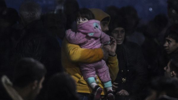 Syrian refugees are detained by the Turkish coastguard after they tried to reach the Greek island of Lesbos on March 3, 2016, Kucukkuyu, Canakkale. Syrian refugees are detained by the Turkish coastguard after they tried to reach the Greek island of Lesbos on March 3, 2016, Kucukkuyu, Canakkale. - Sputnik International