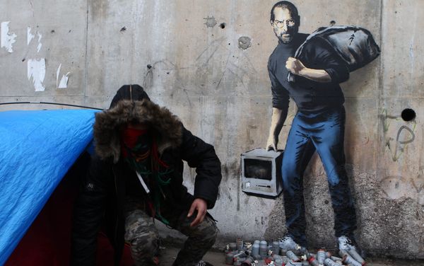 A painting by English graffiti artist Banksy is seen at the entrance of the Calais refugee camp in France A painting by English graffiti artist Banksy is seen at the entrance of the Calais refugee camp in France - Sputnik International