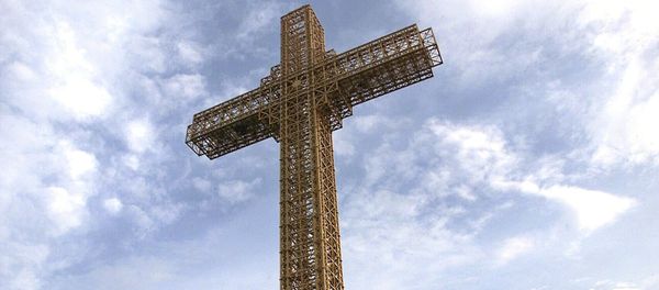 Macedonian Orthodox believers sit around a massive metal cross during its sanctification ceremony on top of Mt. Vodno, just above Macedonia's capital Skopje, on Wednesday, Aug. 28, 2002 Macedonian Orthodox believers sit around a massive metal cross during its sanctification ceremony on top of Mt. Vodno, just above Macedonia's capital Skopje, on Wednesday, Aug. 28, 2002 - Sputnik International