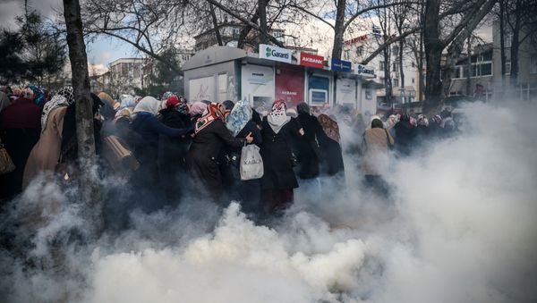 Smoke rises near a group of women as Turkish anti-riot police officers use tear gas to disperse supporters in front of the headquarters of the Turkish daily newspaper Zaman in Istanbul on March 5, 2016, after Turkish authorities seized the headquarters in a midnight raid - Sputnik International