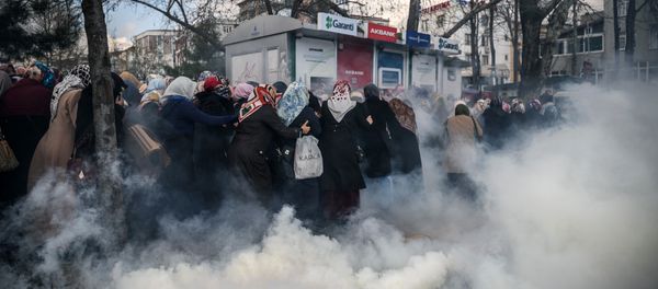 Smoke rises near a group of women as Turkish anti-riot police officers use tear gas to disperse supporters in front of the headquarters of the Turkish daily newspaper Zaman in Istanbul on March 5, 2016, after Turkish authorities seized the headquarters in a midnight raid Smoke rises near a group of women as Turkish anti-riot police officers use tear gas to disperse supporters in front of the headquarters of the Turkish daily newspaper Zaman in Istanbul on March 5, 2016, after Turkish authorities seized the headquarters in a midnight raid - Sputnik International