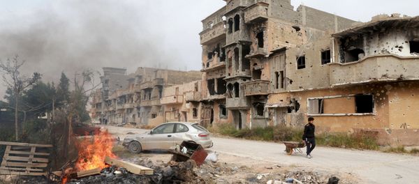 A man pulls a wheelbarrow past destroyed buildings after clashes between military forces loyal to Libya's eastern government and Islamist fighters, in Benghazi, Libya, February 28, 2016 A man pulls a wheelbarrow past destroyed buildings after clashes between military forces loyal to Libya's eastern government and Islamist fighters, in Benghazi, Libya, February 28, 2016 - Sputnik International