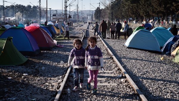 Sisters walk on railway tracks where refugees installed their tents at the makeshift camp of the Greek-Macedonian border near the Greek village of Idomeni, on March 5, 2016, where thousands of refugees and migrants wait to cross the border into Macedonia Sisters walk on railway tracks where refugees installed their tents at the makeshift camp of the Greek-Macedonian border near the Greek village of Idomeni, on March 5, 2016, where thousands of refugees and migrants wait to cross the border into Macedonia - Sputnik International