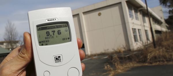 Reuters reporter measures a radiation level of 9.76 microsieverts per hour in front of Kumamachi Elementary School inside the exclusion zone in Okuma, near Tokyo Electric Power Co's (TEPCO) tsunami-crippled Fukushima Daiichi nuclear power plant, Fukushima Prefecture, Japan, February 13, 2016 - Sputnik International