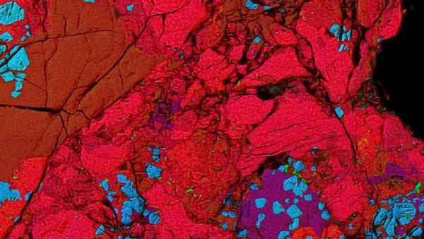 This close-up picture shows a ceramic-like refractory inclusion (pink inclusion) still embedded into the meteorite in which it was found - Sputnik International