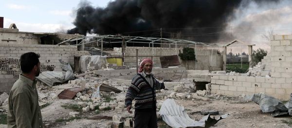 A Syrian man stands in the courtyard of his farm as smoke billows in the background following reported air strikes near the rebel-held village of al-Chifouniya, on the outskirts of the capital Damascus, on March 4, 2016 A Syrian man stands in the courtyard of his farm as smoke billows in the background following reported air strikes near the rebel-held village of al-Chifouniya, on the outskirts of the capital Damascus, on March 4, 2016 - Sputnik International