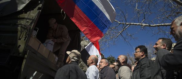 Local residents line up to get a food aid from a Russian military truck Local residents line up to get a food aid from a Russian military truck - Sputnik International