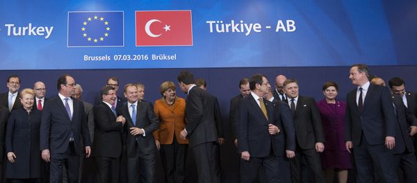French President Francois Hollande (2nd L front row) looks on as Turkish Prime Minister Ahmet Davutoglu (3rd L) chats with European Council President Donald Tusk (4th L) while posing with European Union leaders during a EU-Turkey summit in Brussels, as the bloc is looking to Ankara to help it curb the influx of refugees and migrants flowing into Europe, March 7, 2016 French President Francois Hollande (2nd L front row) looks on as Turkish Prime Minister Ahmet Davutoglu (3rd L) chats with European Council President Donald Tusk (4th L) while posing with European Union leaders during a EU-Turkey summit in Brussels, as the bloc is looking to Ankara to help it curb the influx of refugees and migrants flowing into Europe, March 7, 2016 - Sputnik International