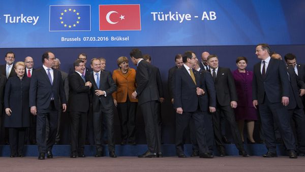 French President Francois Hollande (2nd L front row) looks on as Turkish Prime Minister Ahmet Davutoglu (3rd L) chats with European Council President Donald Tusk (4th L) while posing with European Union leaders during a EU-Turkey summit in Brussels, as the bloc is looking to Ankara to help it curb the influx of refugees and migrants flowing into Europe, March 7, 2016 French President Francois Hollande (2nd L front row) looks on as Turkish Prime Minister Ahmet Davutoglu (3rd L) chats with European Council President Donald Tusk (4th L) while posing with European Union leaders during a EU-Turkey summit in Brussels, as the bloc is looking to Ankara to help it curb the influx of refugees and migrants flowing into Europe, March 7, 2016 - Sputnik International