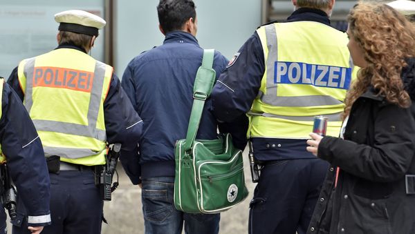 Police lead away a man at the main train station Tuesday, Jan. 12, 2016, in Cologne, Germany Police lead away a man at the main train station Tuesday, Jan. 12, 2016, in Cologne, Germany - Sputnik International