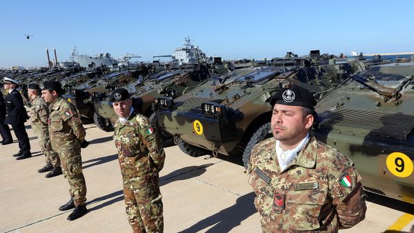 Italian Army soldiers stand by some of the twenty military vehicles during an handing over ceremony by Italy to Libya at a Libyan Navy Base on February 6, 2013 in Tripoli. Italian Army soldiers stand by some of the twenty military vehicles during an handing over ceremony by Italy to Libya at a Libyan Navy Base on February 6, 2013 in Tripoli. - Sputnik International