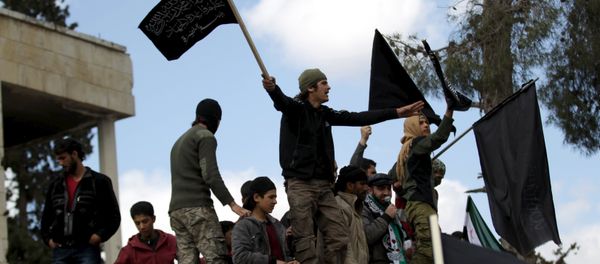 Protesters carry Nusra Front flags and shout slogans during an anti-government protest after Friday prayers in the town of Marat Numan in Idlib province, Syria, March 11, 2016 - Sputnik International
