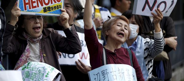 People protesting the planned relocation of the U.S. military base, to Okinawa's Henoko coast, shout slogans at a rally in front of Prime Minister Shinzo Abe's official residence, as a meeting between Okinawa Governor Takeshi Onaga and Abe is held, in Tokyo in this April 17, 2015 file photo People protesting the planned relocation of the U.S. military base, to Okinawa's Henoko coast, shout slogans at a rally in front of Prime Minister Shinzo Abe's official residence, as a meeting between Okinawa Governor Takeshi Onaga and Abe is held, in Tokyo in this April 17, 2015 file photo - Sputnik International