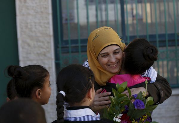 Palestinian teacher Hanan al-Hroub, who is shortlisted to win the Global Teacher Prize, is hugged by a student in the West Bank city of Ramallah February 17, 2016 Palestinian teacher Hanan al-Hroub, who is shortlisted to win the Global Teacher Prize, is hugged by a student in the West Bank city of Ramallah February 17, 2016 - Sputnik International
