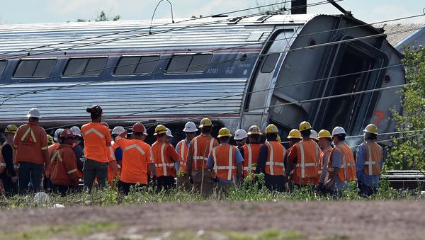 Rescuers gather around a derailed carriage of an Amtrak train in Philadelphia, Pennsylvania, on May 13, 2015 file photo - Sputnik International