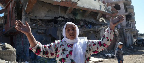 A woman reacts while walking among the rubble of damaged buildings following heavy fighting between government troops and Kurdish fighters in the Kurdish town of Cizre in southeastern Turkey, which lies near the border with Syria and Iraq, on March 2, 2016 A woman reacts while walking among the rubble of damaged buildings following heavy fighting between government troops and Kurdish fighters in the Kurdish town of Cizre in southeastern Turkey, which lies near the border with Syria and Iraq, on March 2, 2016 - Sputnik International