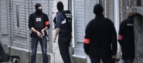 Police officers take position at the site of a shooting in the southern Forest district of Brussels on March 15, 2016 Police officers take position at the site of a shooting in the southern Forest district of Brussels on March 15, 2016 - Sputnik International