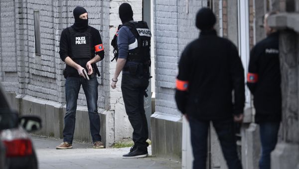 Police officers take position at the site of a shooting in the southern Forest district of Brussels on March 15, 2016 Police officers take position at the site of a shooting in the southern Forest district of Brussels on March 15, 2016 - Sputnik International