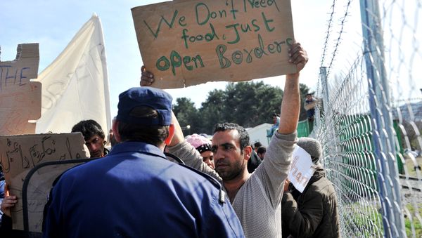 Refugees from Afghanistan protest against the closure of the Greek-Macedonian border near the village of Idomeni, northern Greece, on February 22, 2016. - Sputnik International