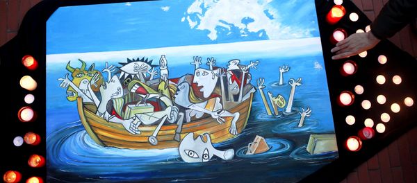 A woman places a candle next to a painting, based on a Picasso painting titled Guernica, depicting the sinking of a boat carrying immigrants during a protest against the EU-Turkey migrant deal in Malaga, southern Spain, March 16, 2016. A woman places a candle next to a painting, based on a Picasso painting titled Guernica, depicting the sinking of a boat carrying immigrants during a protest against the EU-Turkey migrant deal in Malaga, southern Spain, March 16, 2016. - Sputnik International