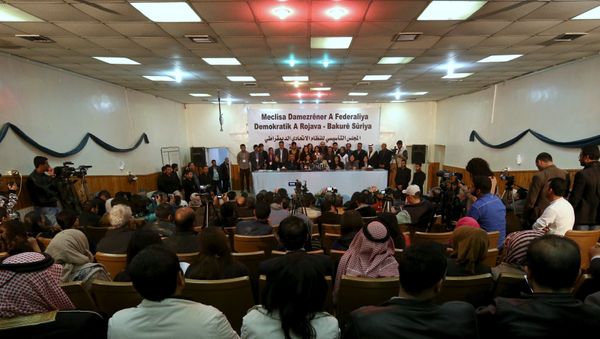 Delegates take part in a conference where they announced a federal system in Syria's Kurdish-controlled northern regions, in the town of Rmeilan, Hasaka province, Syria - Sputnik International
