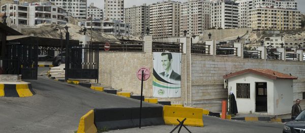 A portrait of Syrian President Bashar Assad is mounted on a wall in Damascus, Syria, Thursday, March 3, 2016. - Sputnik International