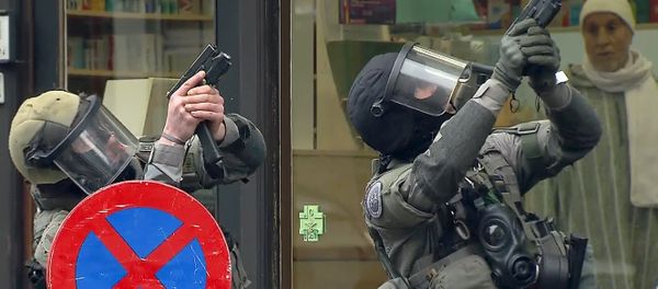 Armed Belgian police secure the area, in this still image taken from video, upon their arrival in Molenbeeck, near Brussels, Belgium Armed Belgian police secure the area, in this still image taken from video, upon their arrival in Molenbeeck, near Brussels, Belgium - Sputnik International