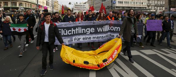 Protesters hold up banners and a rubber boat during a demonstration Refugees Welcome! No to Fortress Europe in Vienna, Austria Protesters hold up banners and a rubber boat during a demonstration Refugees Welcome! No to Fortress Europe in Vienna, Austria - Sputnik International
