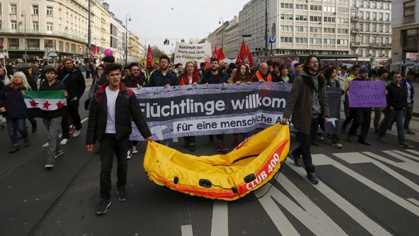 Protesters hold up banners and a rubber boat during a demonstration Refugees Welcome! No to Fortress Europe in Vienna, Austria Protesters hold up banners and a rubber boat during a demonstration Refugees Welcome! No to Fortress Europe in Vienna, Austria - Sputnik International