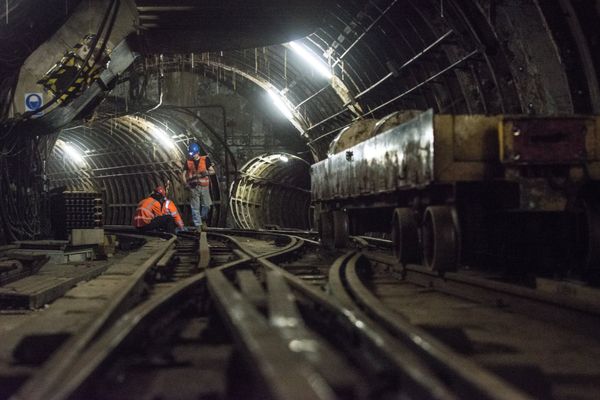 Workers sit on the underground tracks of the Mail Rail, the old rail system that transported mail between sorting offices, as work starts to turn it into a heritage attraction at the new Postal Museum in London - Sputnik International