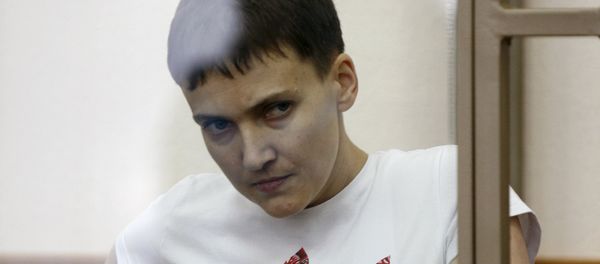 Former Ukrainian army pilot Nadezhda Savchenko looks out from a glass-walled cage as she attends a court hearing in the southern border town of Donetsk in Rostov region, Russia, in this file picture taken March 9, 2016 - Sputnik International