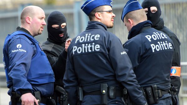 Policemen speak at a security perimeter near Maalbeek metro station, on March 22, 2016 in Brussels, after a blast at this station near the EU institutions caused deaths and injuries - Sputnik International