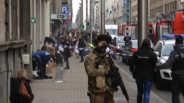 In this image taken from TV an armed member of the security forces stands guard as emergency services attend the scene after a explosion in a main metro station in Brussels on Tuesday, March 22, 2016 - Sputnik International