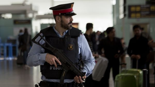 A police officer guards a terminal of the airport during tighter security measures in Barcelona, Spain, Tuesday, March 22, 2016 A police officer guards a terminal of the airport during tighter security measures in Barcelona, Spain, Tuesday, March 22, 2016 - Sputnik International