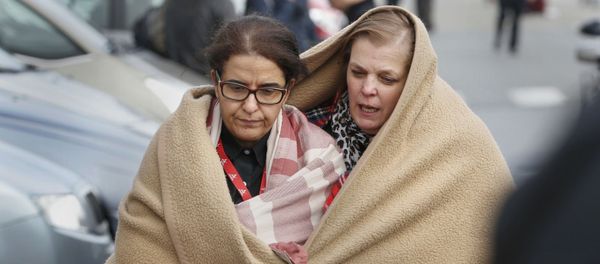 People wrapped in blankets leave the scene of explosions at Zaventem airport near Brussels, Belgium, March 22, 2016 - Sputnik International