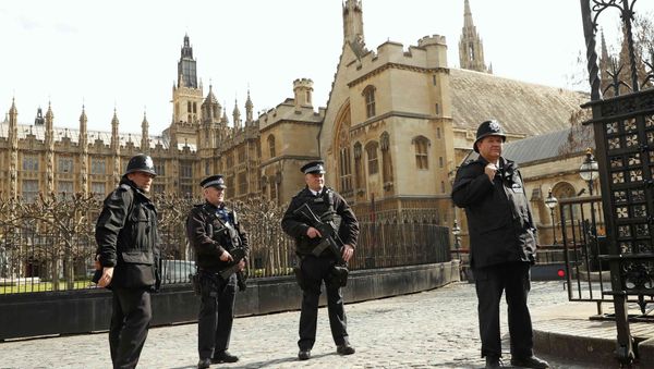 Armed police stand on guard at the Houses of Parliament in London, Britain March 22, 2016. Britain's Prime Minister David Cameron said he would chair a crisis response meeting following explosions in Brussels on Tuesday Armed police stand on guard at the Houses of Parliament in London, Britain March 22, 2016. Britain's Prime Minister David Cameron said he would chair a crisis response meeting following explosions in Brussels on Tuesday - Sputnik International