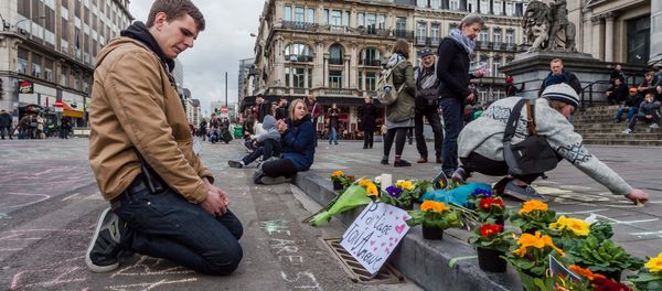 A man looks at flowers and messages outside the stock exchange in Brussels on Tuesday, March 22, 2016 A man looks at flowers and messages outside the stock exchange in Brussels on Tuesday, March 22, 2016 - Sputnik International