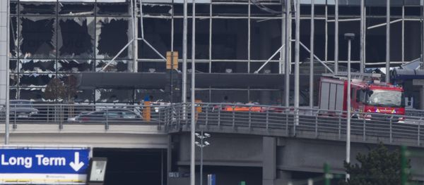 The blown out facade of the terminal is seen as a fire truck drives down the ramp at Zaventem airport, one of the sites of two deadly attacks in Brussels, Belgium, Tuesday, March 22, 2016 - Sputnik International