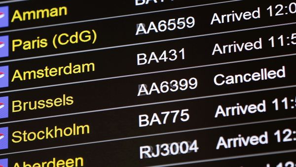 An arrivals board displays a cancelled flight from Brussels with an American Airlines code at Terminal 5, Heathrow Airport in London, Britain March 22, 2016 - Sputnik International