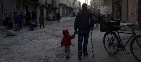 An injured Syrian man walks holding his daughter's hand in Barza, a northern suburb of the capital Damascus, on March 22, 2016 An injured Syrian man walks holding his daughter's hand in Barza, a northern suburb of the capital Damascus, on March 22, 2016 - Sputnik International