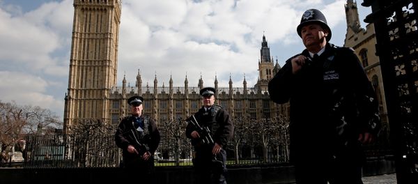 Armed British police officers stand on duty in front of the Elzabeth Tower, better known as Big Ben, outside the vehicle entrance to the Houses of Parliament in central London on March 22, 2016. - Sputnik International