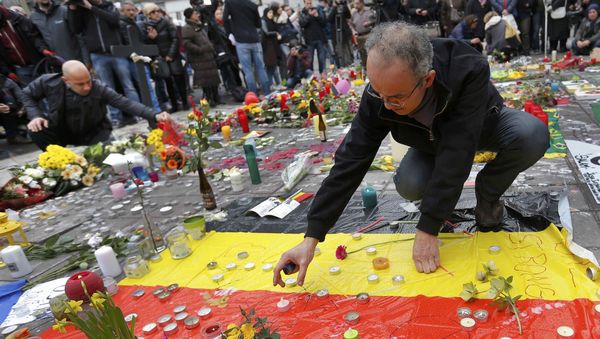 Men place a candles on a street memorial following Tuesday's bomb attacks in Brussels, Belgium, March 23, 2016 Men place a candles on a street memorial following Tuesday's bomb attacks in Brussels, Belgium, March 23, 2016 - Sputnik International