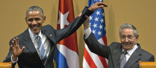 Cuban President Raul Castro, right, lifts up the arm of President Barack Obama at the conclusion of their joint news conference at the Palace of the Revolution, Monday, March 21, 2016, in Havana, Cuba Cuban President Raul Castro, right, lifts up the arm of President Barack Obama at the conclusion of their joint news conference at the Palace of the Revolution, Monday, March 21, 2016, in Havana, Cuba - Sputnik International