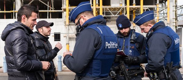 Police officers check the pasports of two men as they try to cross the French-Belgian border in Adinkerke, Belgium, on Wednesday, Feb. 24, 2016 Police officers check the pasports of two men as they try to cross the French-Belgian border in Adinkerke, Belgium, on Wednesday, Feb. 24, 2016 - Sputnik International