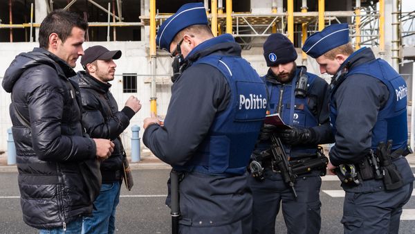 Police officers check the pasports of two men as they try to cross the French-Belgian border in Adinkerke, Belgium, on Wednesday, Feb. 24, 2016 Police officers check the pasports of two men as they try to cross the French-Belgian border in Adinkerke, Belgium, on Wednesday, Feb. 24, 2016 - Sputnik International